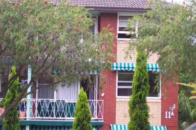 Bright, spacious and well presented top floor apartment with balcony, garage and storage.
