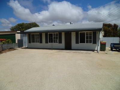 NEAT FURNISHED THREE BEDROOM HOME ON LARGE CORNER BLOCK CLOSE TO BEACH