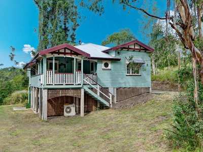 Traditional Queenslander with beautiful open paddocks on a quiet country road